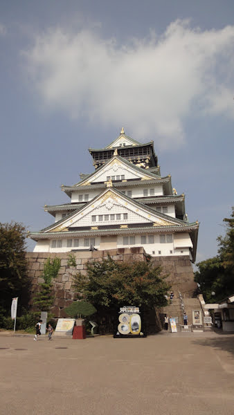 osaka castle's five above ground stories framed by trees